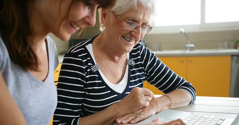 Woman Smiling With Senior Woman